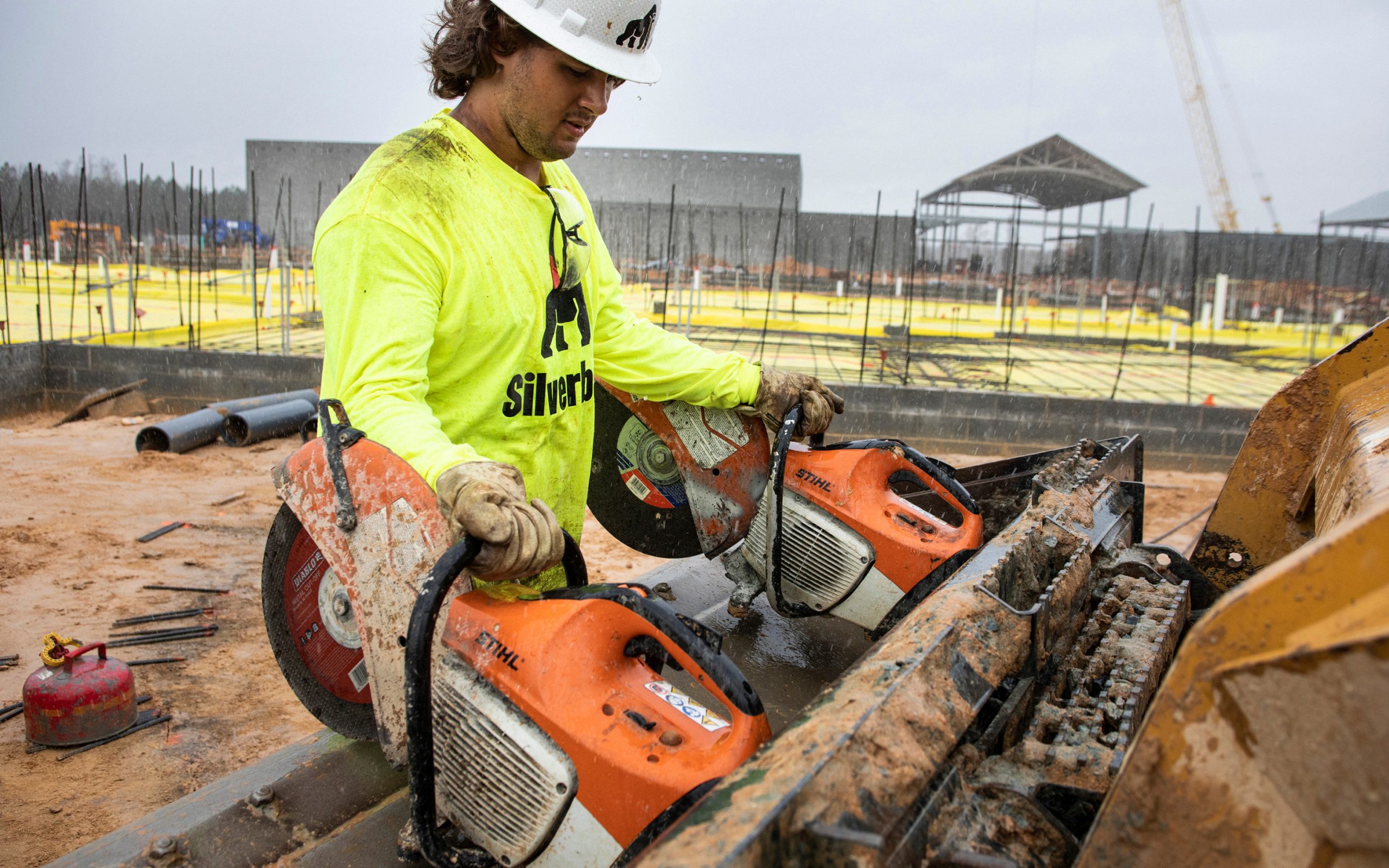 Profession photo of construction worker with equipment; Silverback Concrete.