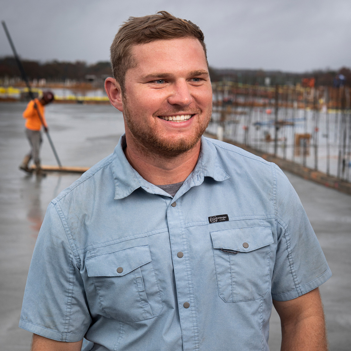 Professional outdoor portrait photo of man on construction site.